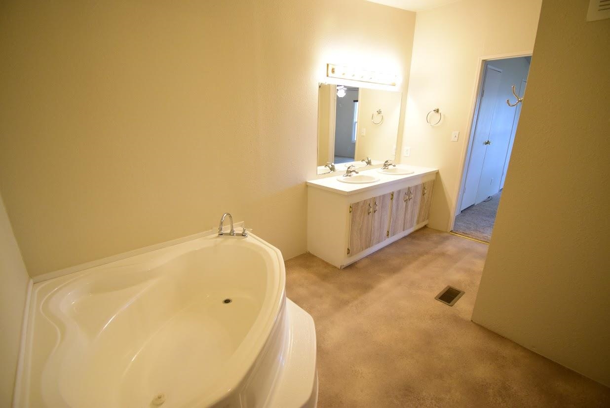 19548 B50 Road Delta, CO 81416 - Photo 16 of 37 a bathroom with a tub sink and mirror