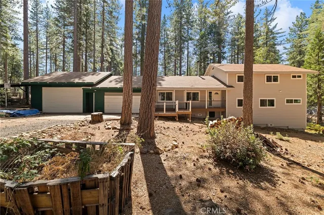 a view of a house with a yard covered with snow in the background