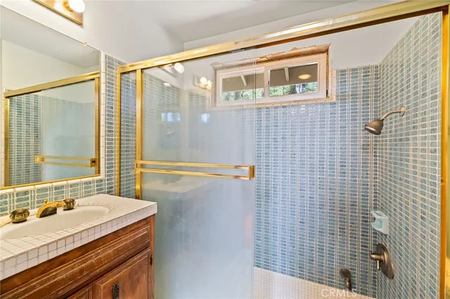 a view of a bedroom with furniture window and a ceiling fan