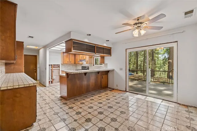 a kitchen with stainless steel appliances granite countertop a sink stove and cabinets
