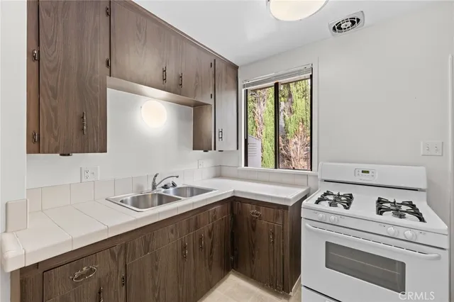 a kitchen with a sink stove and cabinets