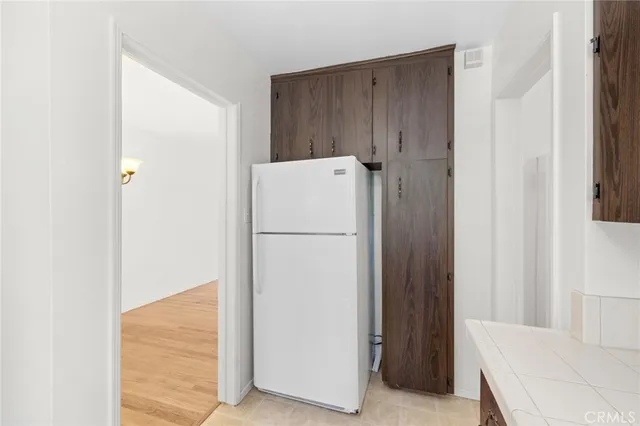 a white refrigerator freezer sitting in a kitchen