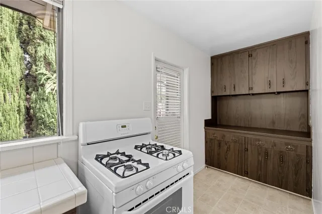 a kitchen with a stove and a refrigerator