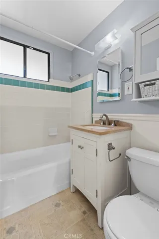 a bathroom with a sink a toilet and bathtub