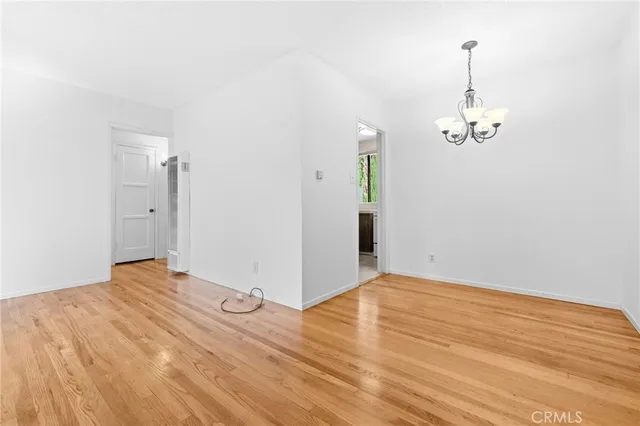 a view of a room with wooden floor and white walls