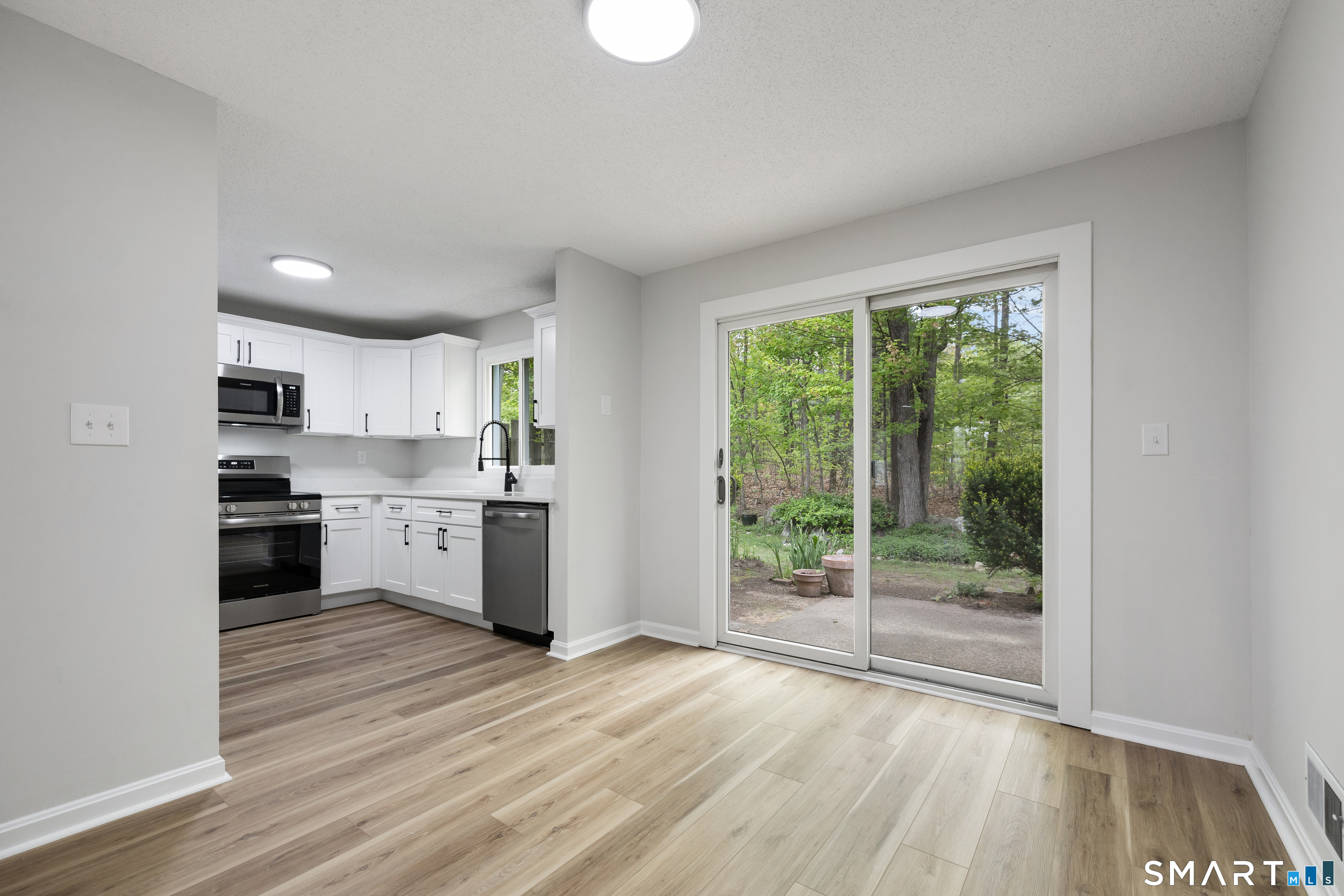 464 Dowd Avenue, Unit 464 Canton, CT 06019 - Photo 7 of 31 Dining room looking out onto patio
