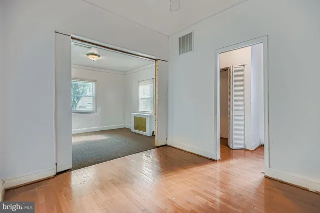 an empty room with windows and entrance