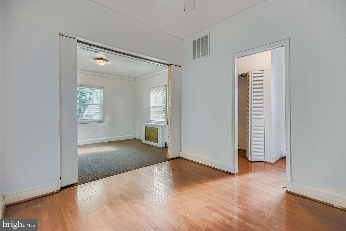 5710 Highgate Drive Baltimore, MD 21215 - Photo 12 of 28 an empty room with windows and entrance
