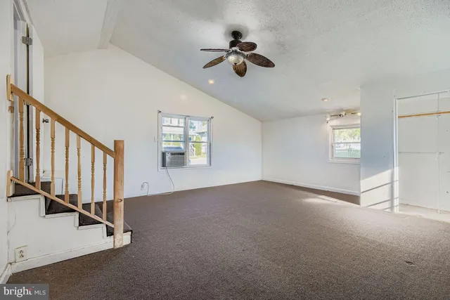 an empty room with windows and entryway