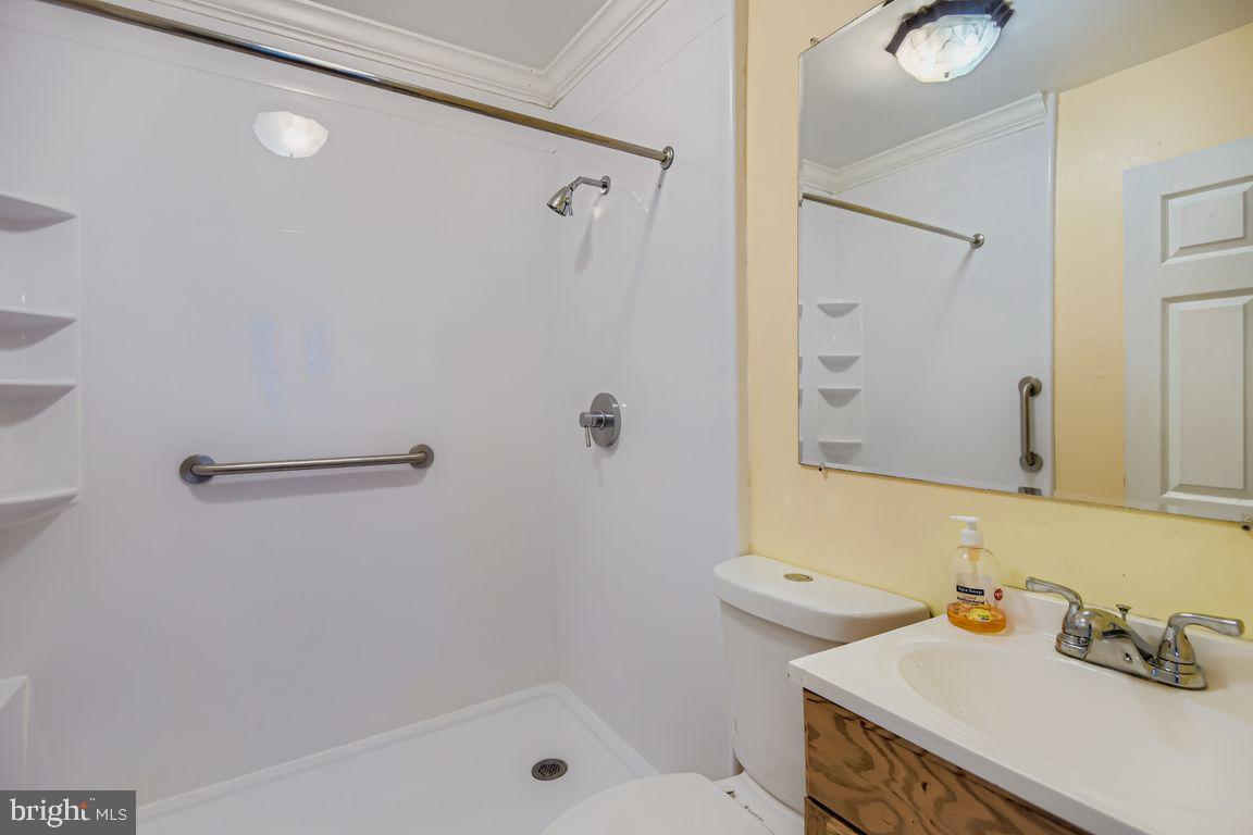 5710 Highgate Drive Baltimore, MD 21215 - Photo 16 of 28 a bathroom with a sink toilet and shower