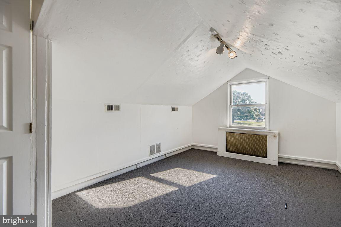 5710 Highgate Drive Baltimore, MD 21215 - Photo 17 of 28 an empty room with windows and closet