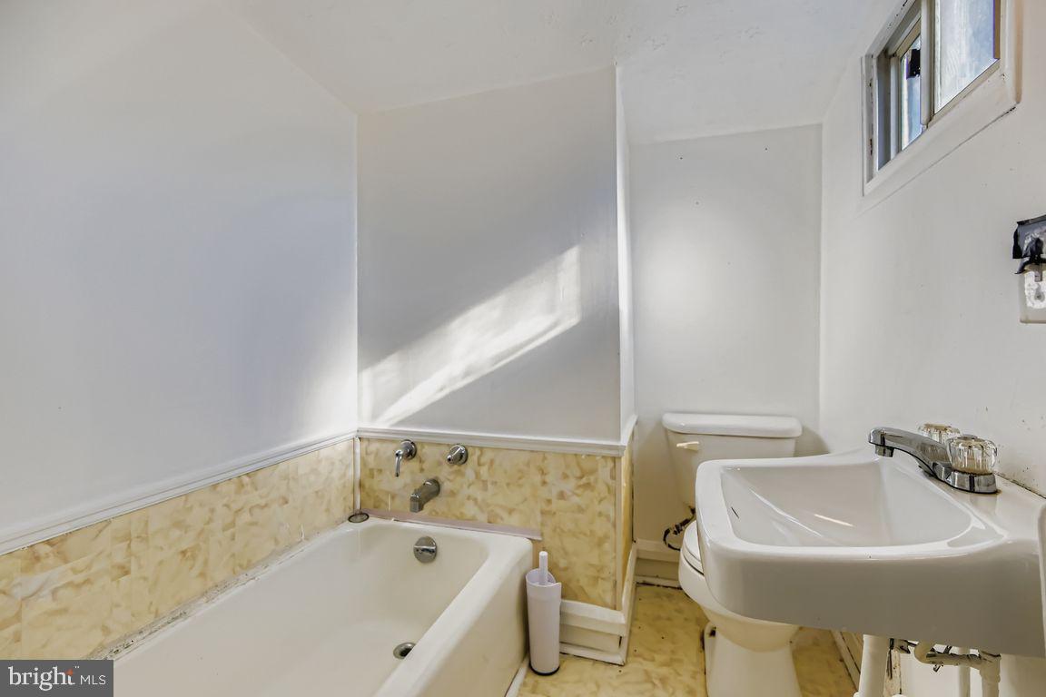 5710 Highgate Drive Baltimore, MD 21215 - Photo 19 of 28 a bathroom with a sink and a bathtub