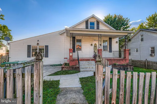 a front view of house with wooden fence