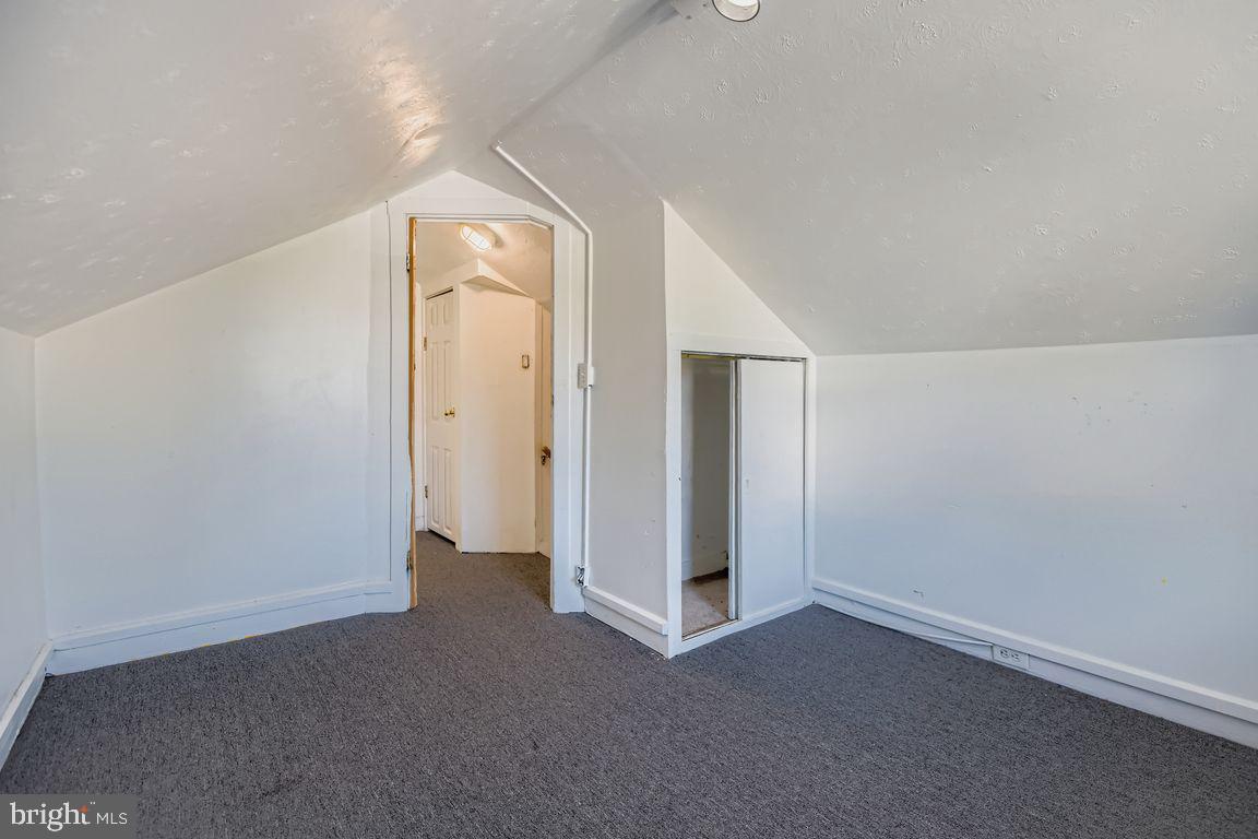 5710 Highgate Drive Baltimore, MD 21215 - Photo 21 of 28 an empty room with closet and mirror