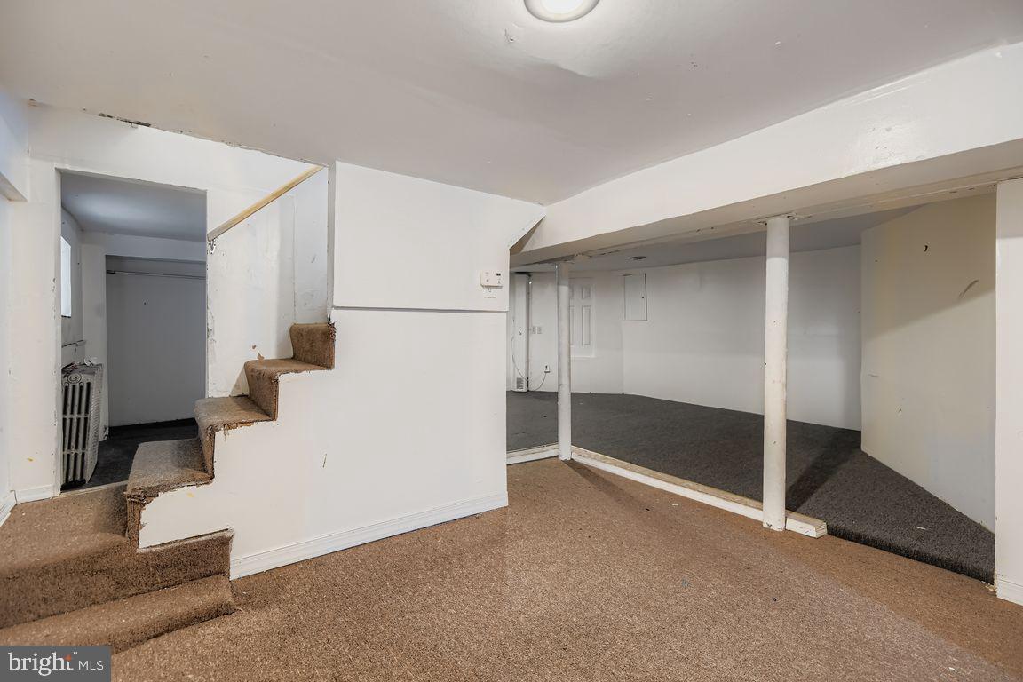 5710 Highgate Drive Baltimore, MD 21215 - Photo 22 of 28 a view of a livingroom with wooden floor and staircase