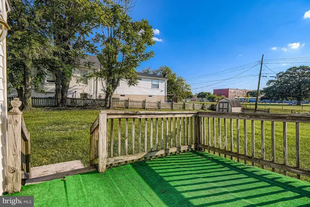 a view of a deck with a big yard