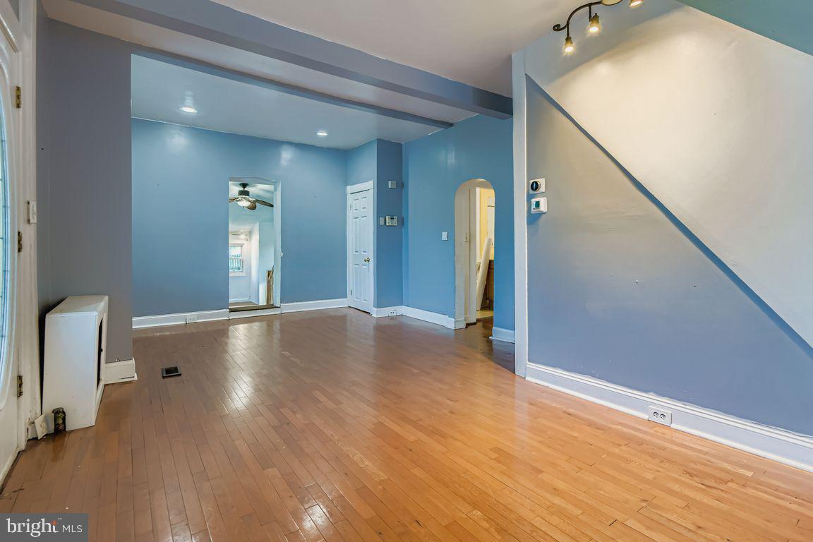 5710 Highgate Drive Baltimore, MD 21215 - Photo 6 of 28 a view of a livingroom with wooden floor and staircase