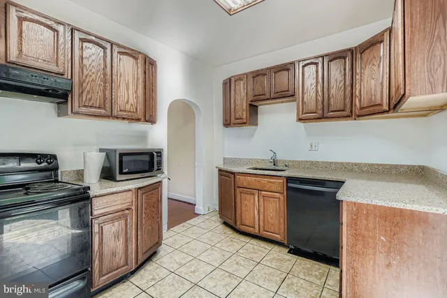 a kitchen with stainless steel appliances granite countertop a stove sink and cabinets
