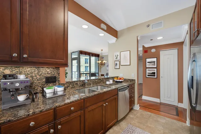 a kitchen with stainless steel appliances granite countertop a sink stove and cabinets