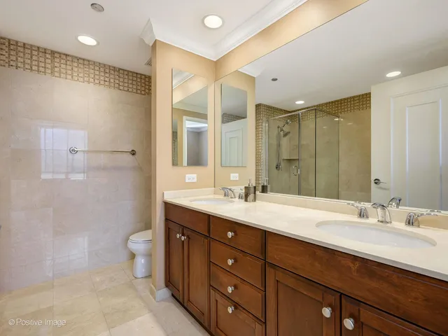a bathroom with a double vanity sink mirror double and shower