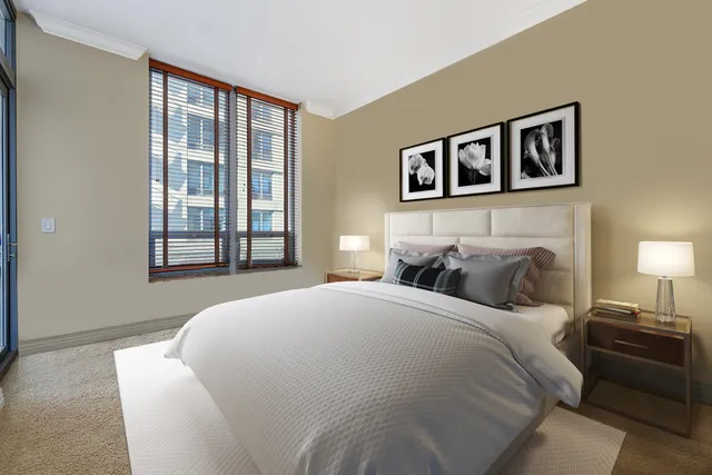 a bedroom with bed and a night stand