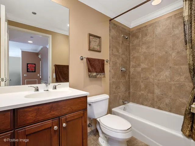 a bathroom with a sink a toilet and shower a mirror