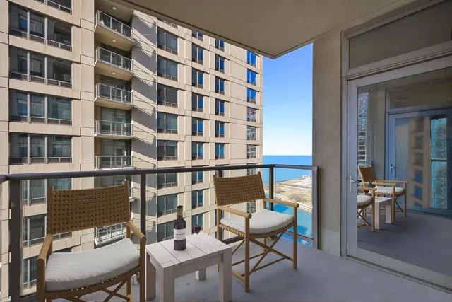 a balcony view with couple of chairs