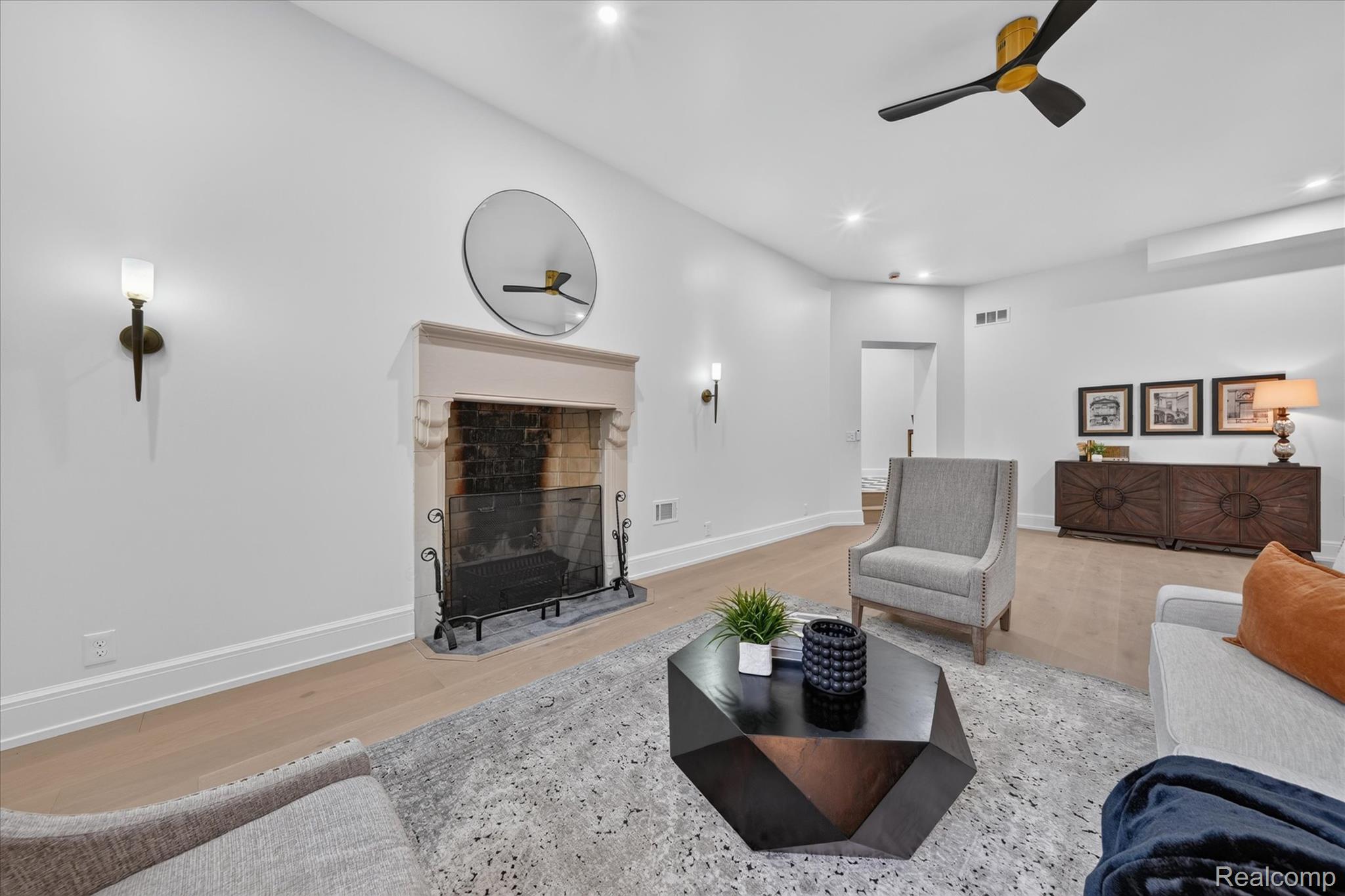 3250 Sherbourne Road Detroit, MI 48221 - Photo 7 of 36 Recessed lighting, wood-finish flooring, and a fireplace with a stone mantel