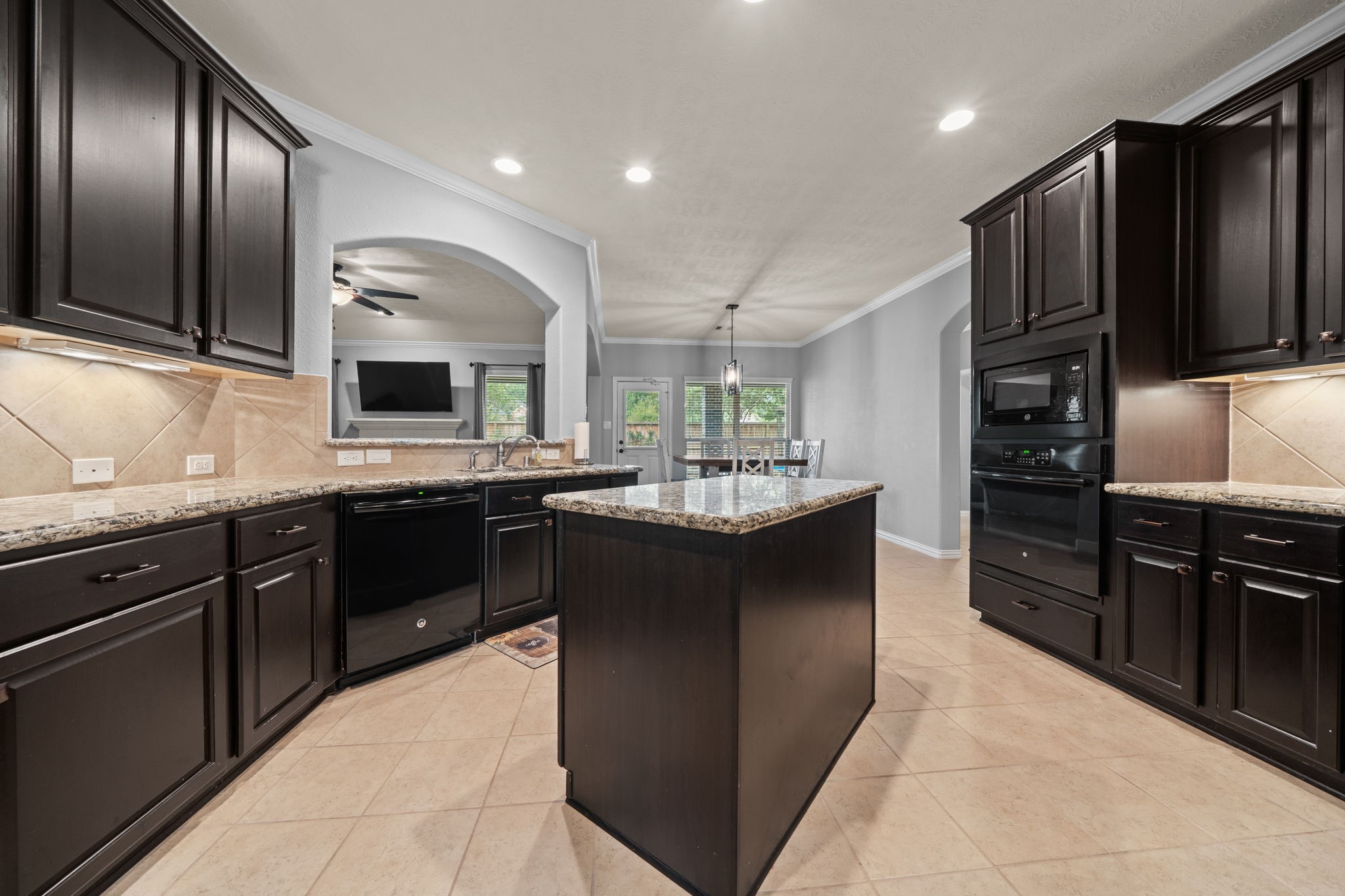 30707 Dodson Trace Drive Spring, TX 77386 - Photo 12 of 43 a kitchen with stainless steel appliances kitchen island granite countertop a refrigerator and a stove top oven