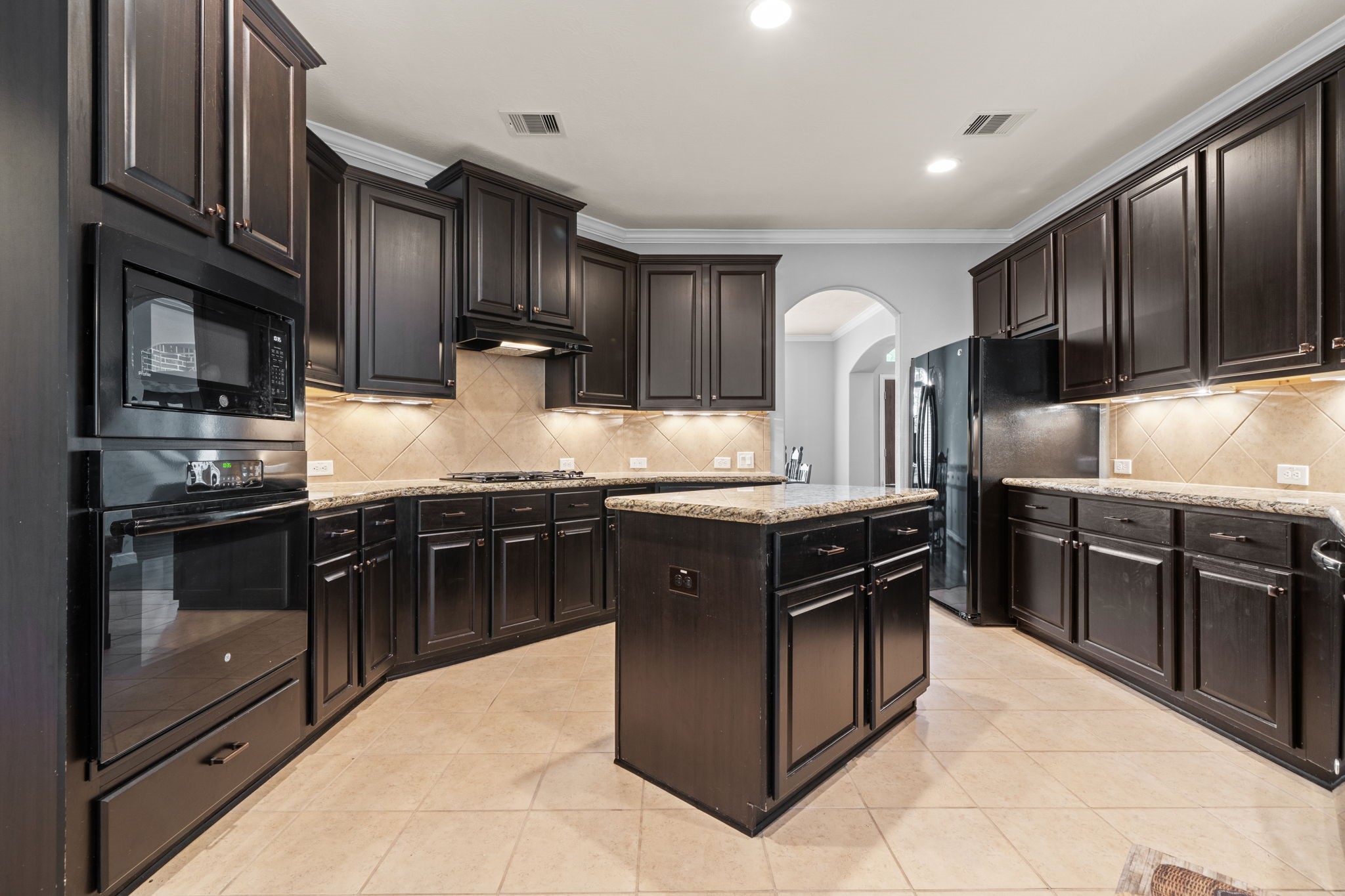 30707 Dodson Trace Drive Spring, TX 77386 - Photo 13 of 43 a kitchen with stainless steel appliances granite countertop a stove microwave and refrigerator