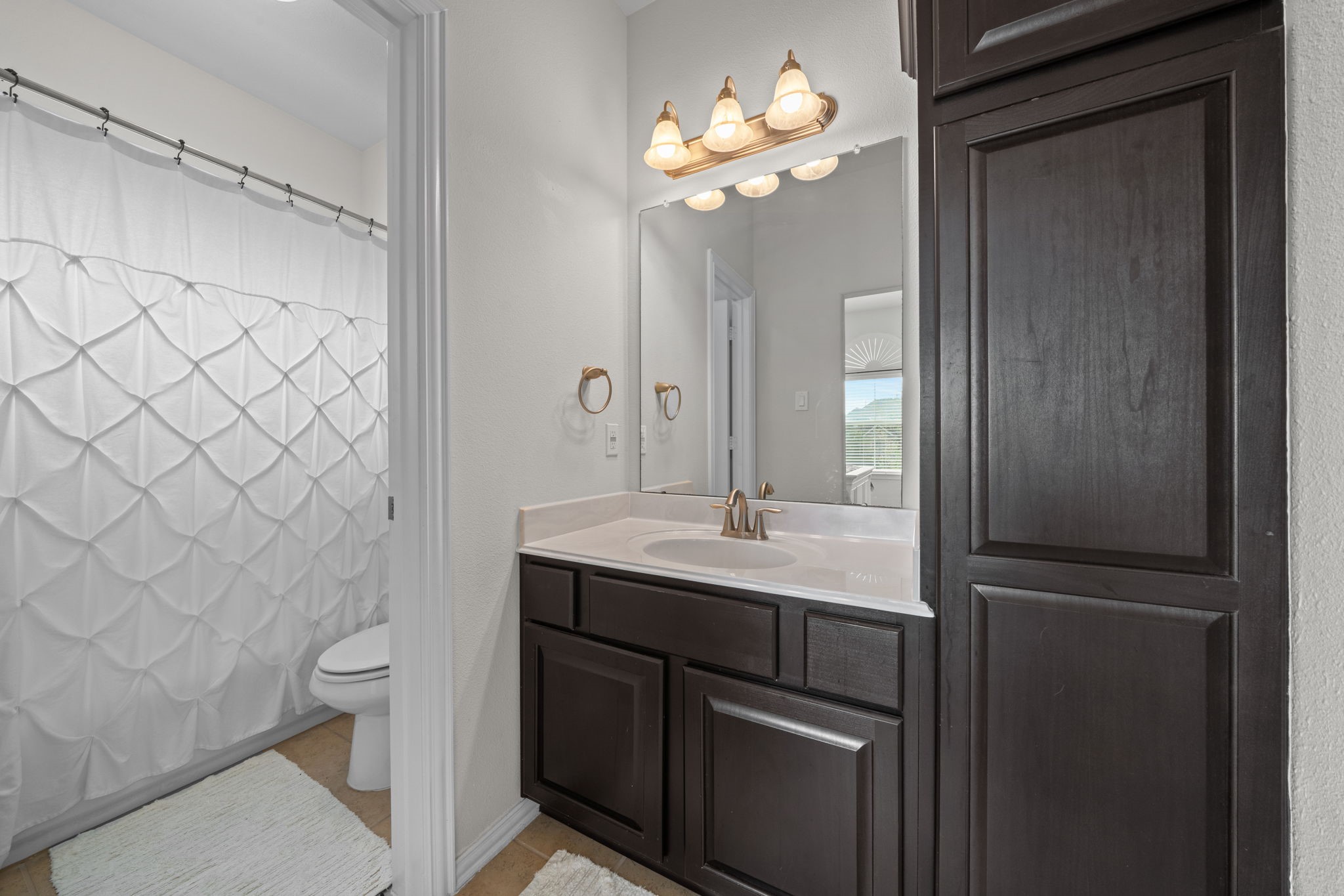 30707 Dodson Trace Drive Spring, TX 77386 - Photo 24 of 43 a bathroom with a sink a toilet and a mirror