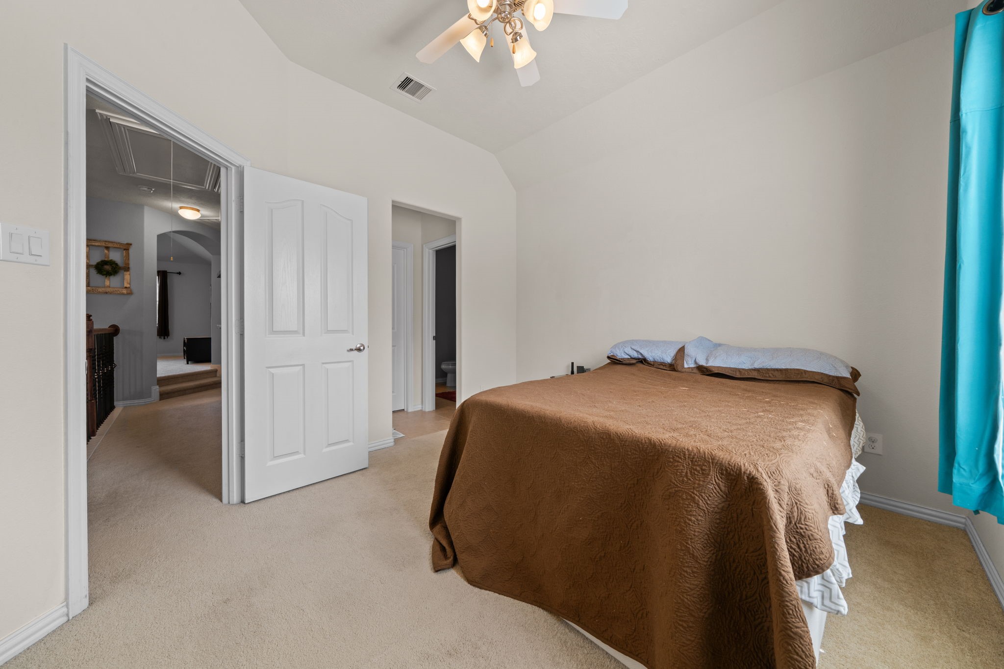 30707 Dodson Trace Drive Spring, TX 77386 - Photo 25 of 43 a spacious bedroom with a bed and a chandelier