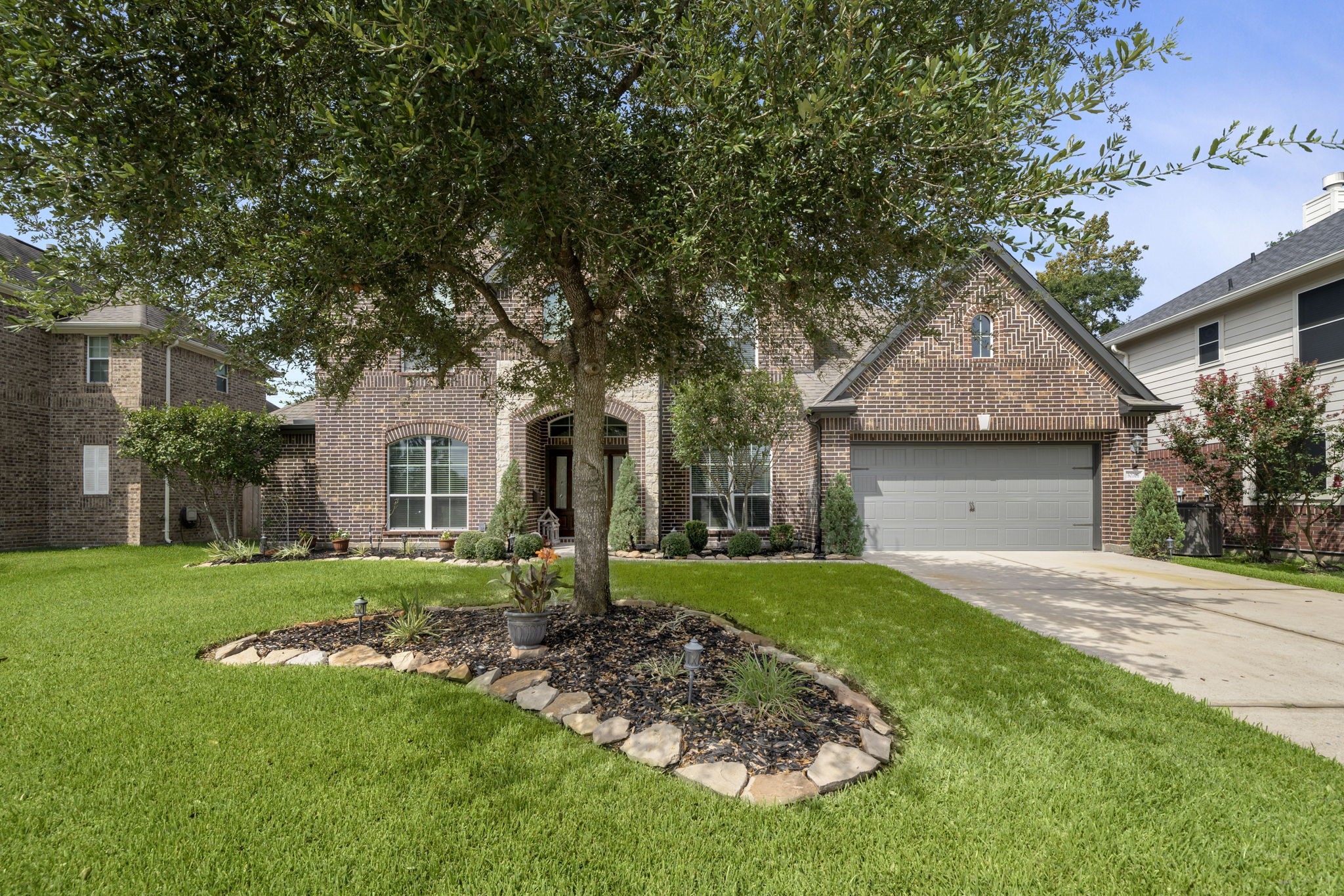 30707 Dodson Trace Drive Spring, TX 77386 - Photo 3 of 43 a front view of a house with a garden and trees