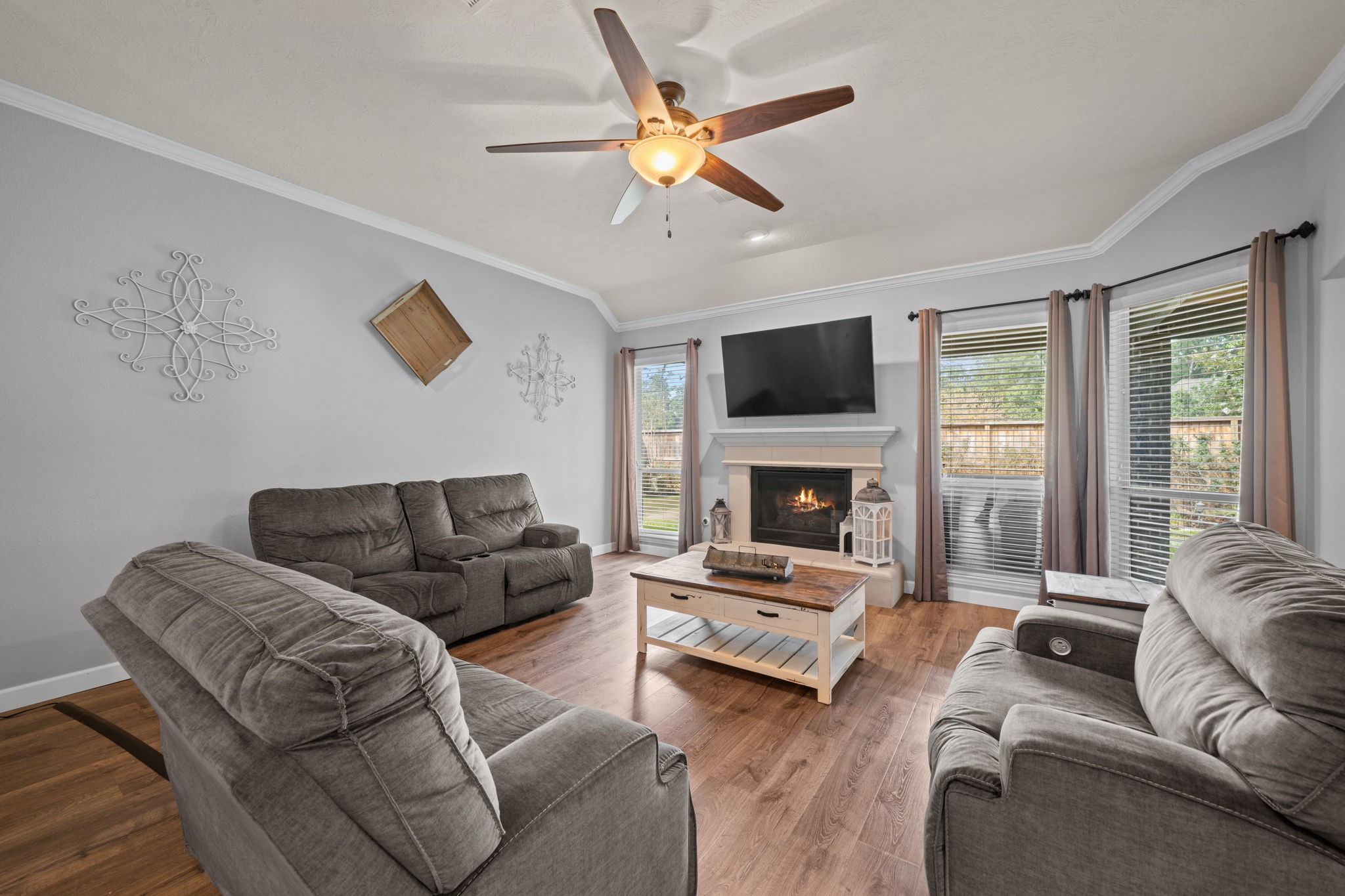 30707 Dodson Trace Drive Spring, TX 77386 - Photo 6 of 43 a living room with furniture a flat screen tv and a fireplace