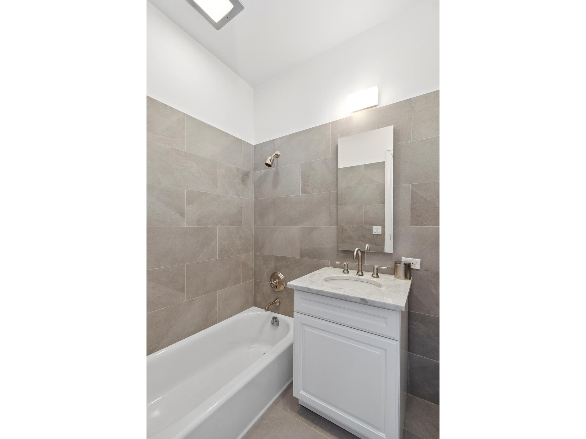 515 Park Avenue, Unit 19 Manhattan, NY 10022 - Photo 12 of 19 a bathroom with a sink toilet and tub