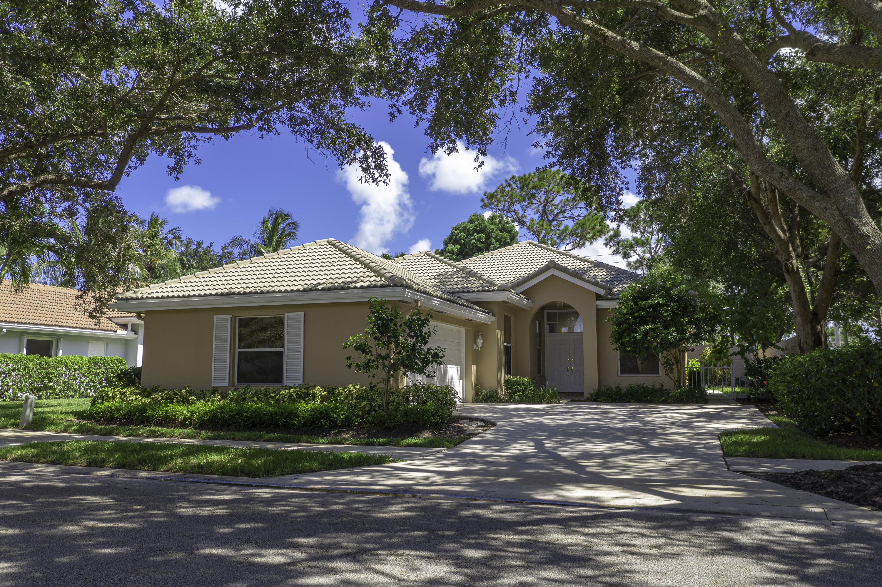168 South Hampton Drive Jupiter, FL 33458 - Photo 20 of 21 a front view of a house with a garden