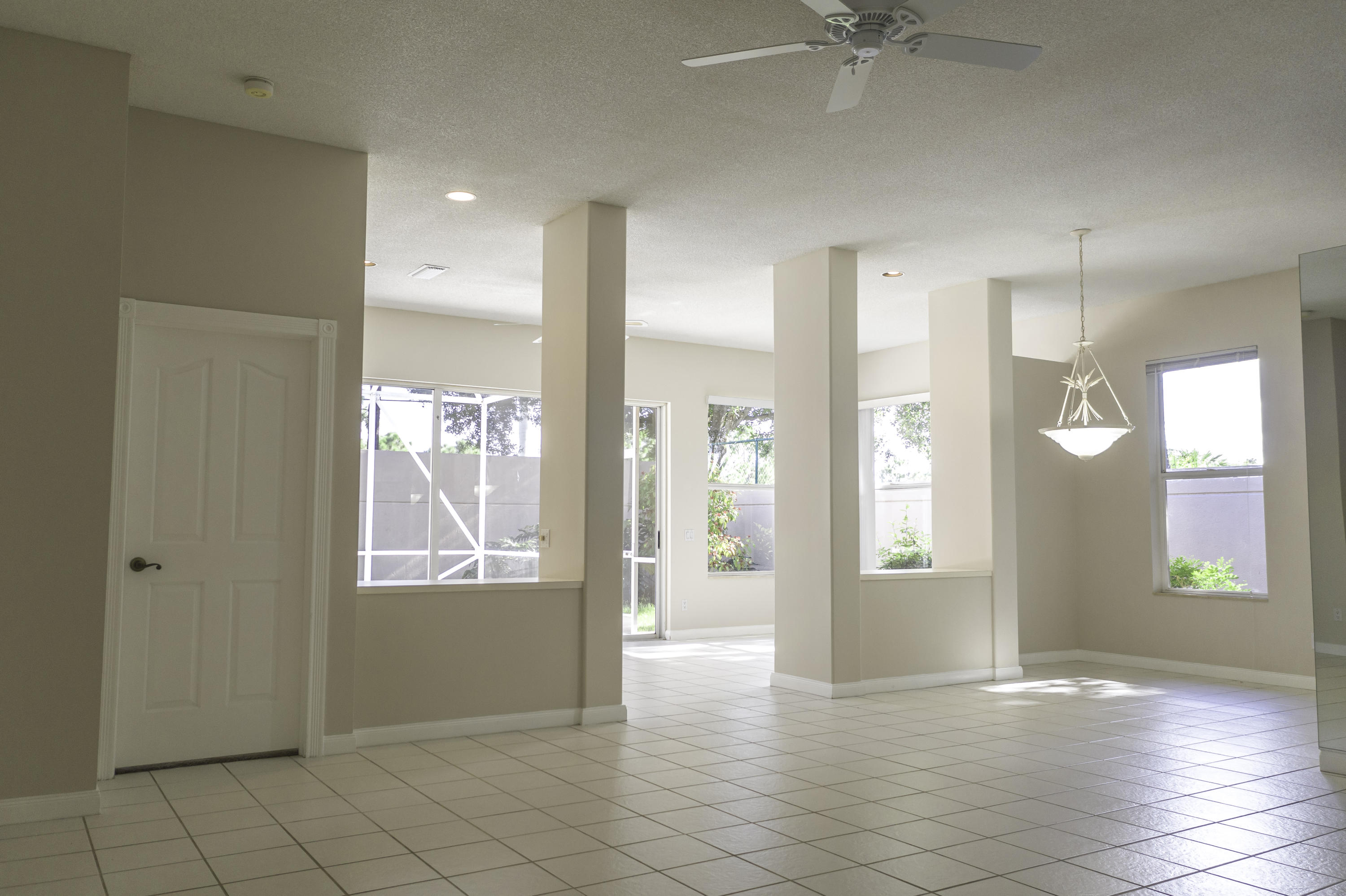 168 South Hampton Drive Jupiter, FL 33458 - Photo 3 of 21 a view of an empty room with window and wooden floor