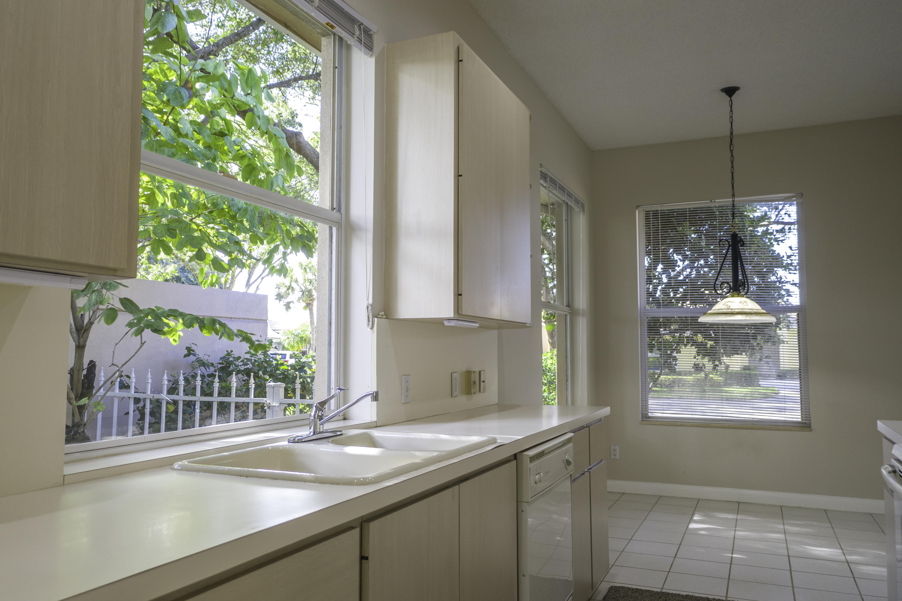168 South Hampton Drive Jupiter, FL 33458 - Photo 4 of 21 a kitchen with a large window sink and cabinets