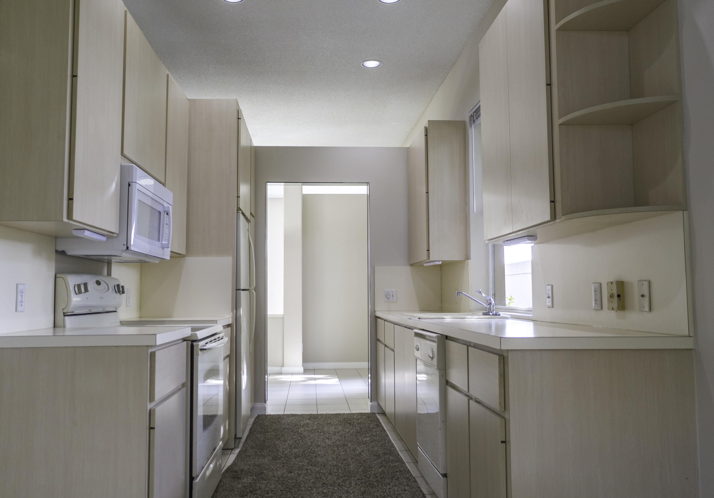 168 South Hampton Drive Jupiter, FL 33458 - Photo 5 of 21 a kitchen with kitchen island a sink stainless steel appliances and cabinets