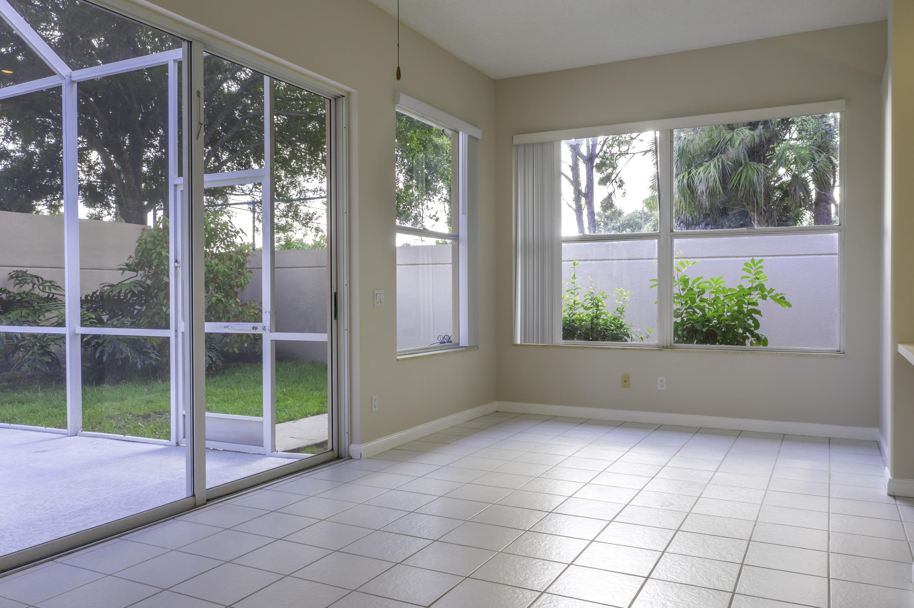 168 South Hampton Drive Jupiter, FL 33458 - Photo 6 of 21 a view of an empty room with wooden floor and a porch