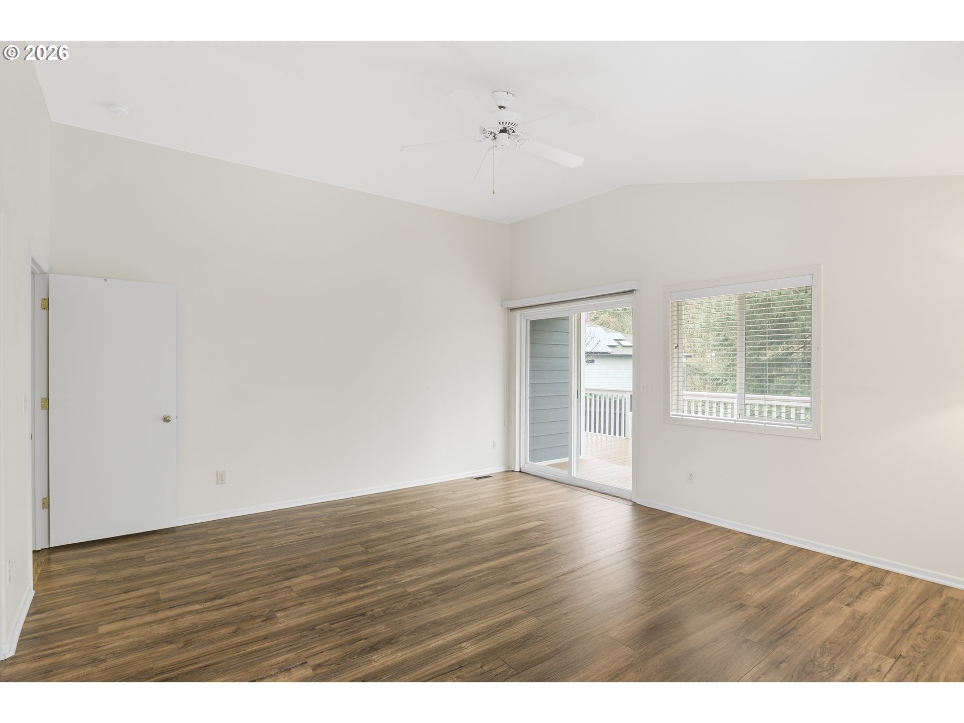 2415 Northwest Norwood Place Camas, WA 98607 - Photo 17 of 36 a view of an empty room with wooden floor and a window