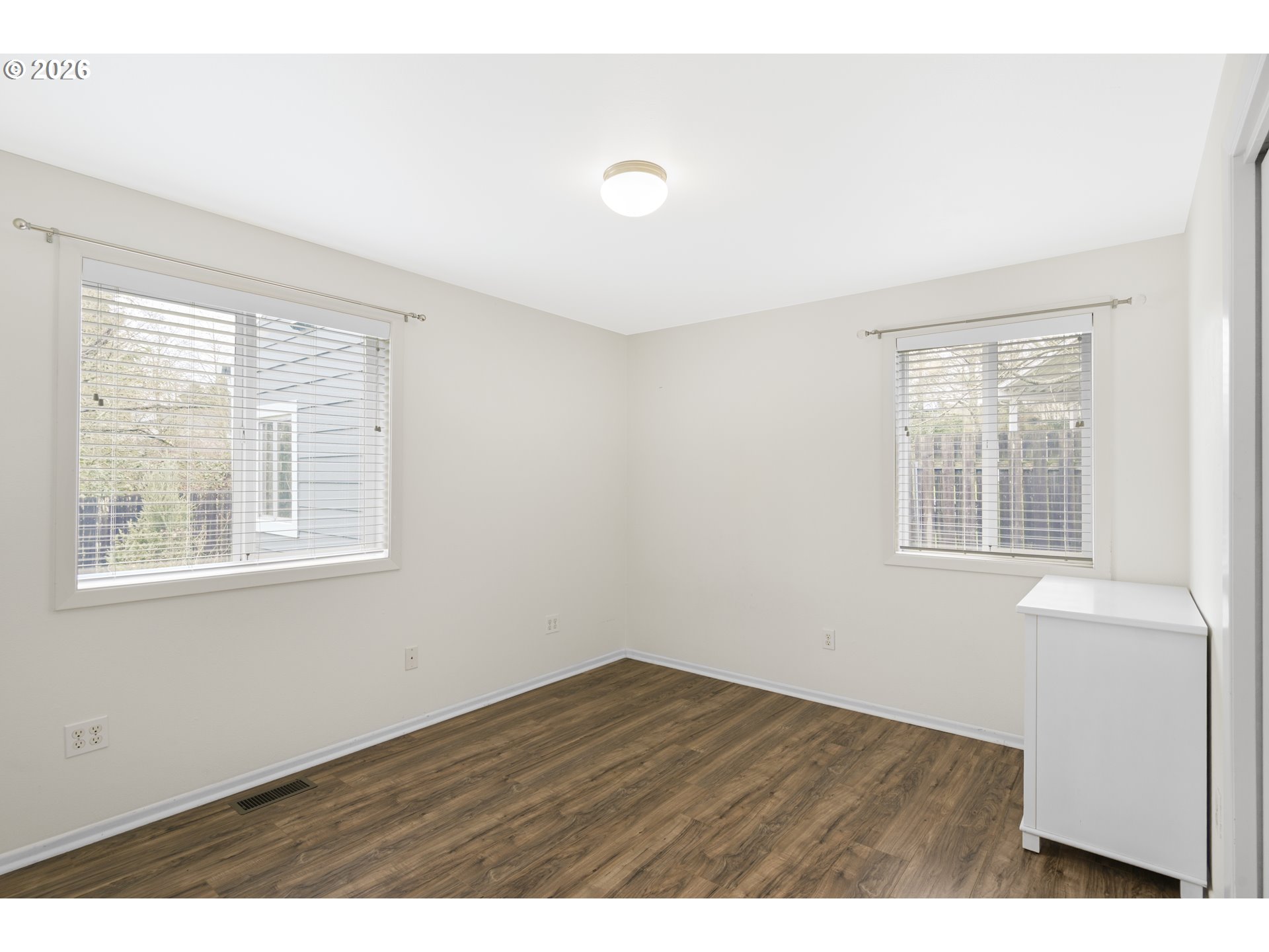 2415 Northwest Norwood Place Camas, WA 98607 - Photo 23 of 36 a view of an empty room with wooden floor and a window
