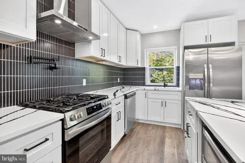 a kitchen with cabinets appliances and a window