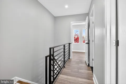 a view of a hallway with wooden floor