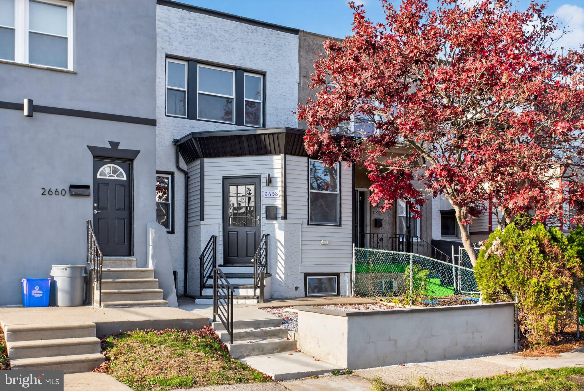 2658 South 68th Street Philadelphia, PA 19142 - Photo 2 of 36 a view of a building with potted plants and a fountain