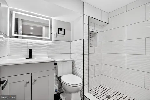 a bathroom with a toilet sink and shower