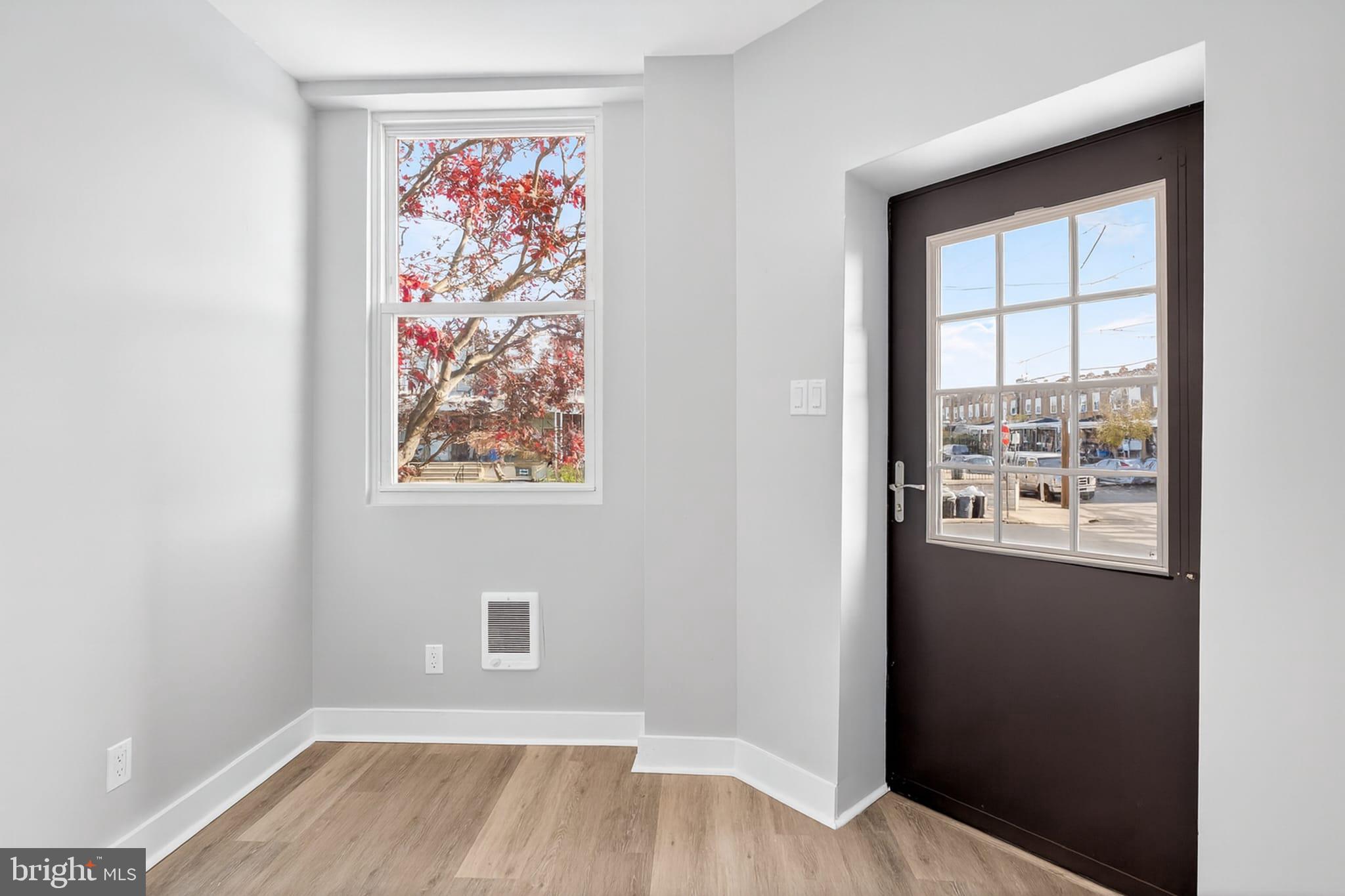 2658 South 68th Street Philadelphia, PA 19142 - Photo 3 of 36 an empty room with wooden floor and windows