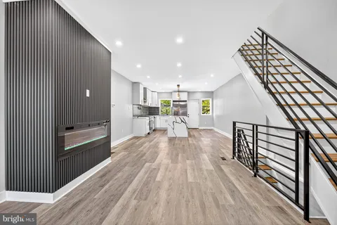 a view of a living room a wooden floor with windows