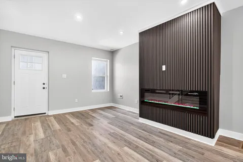 a view of an empty room and wooden floor