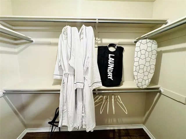 a bedroom with bed and a chandelier